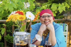 Hispanic Female With Bright Smile Dining Outdoors with Woman who Copes well