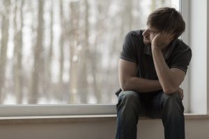 Depressed Man thinking about how to fight depression